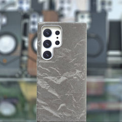 Phone case with marble texture on a blurred background of camera lenses