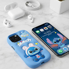 Phone case with cartoon character on a marble surface with phone and earbuds.