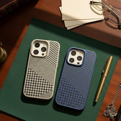 Two phone cases on a green surface with a pen and glasses in the background