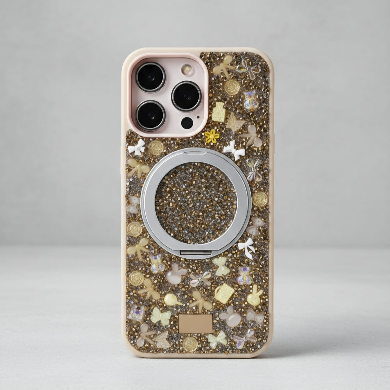 Phone case with decorative elements and ring holder on a gray background