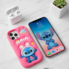 Phone case with cartoon character on a smartphone, next to wireless earbuds and a plant on a light gray surface.