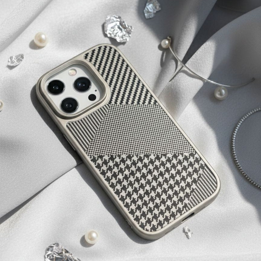 Phone case with houndstooth pattern on a light fabric background