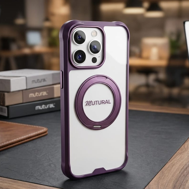 A white and purple MUTURAL MagSafe-compatible phone case stands upright on a dark desk mat in a blurred office-like setting with studio lights visible in the background.