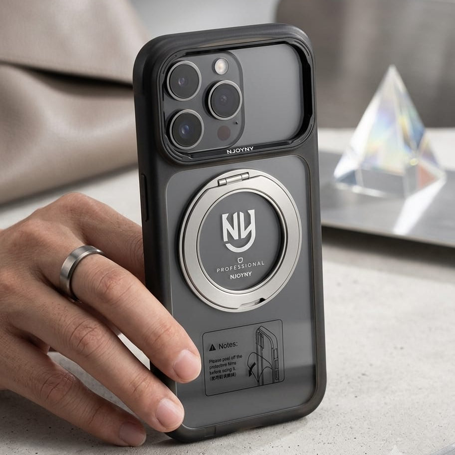 A hand holding a black protective phone case with a built-in circular metal kickstand. The case has a clear back panel and a silver camera bezel, with the NU Personal Notice logo printed on the stand.